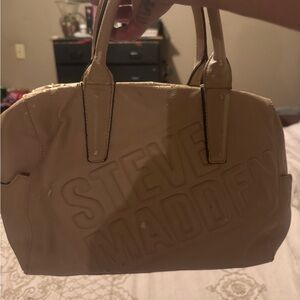 Steve Madden light pinkish tab Embossed Logo Handbag. Comes with longer strap.